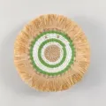 Detailed view of the bohemian woven wall hanging with natural raffia fringe and green white rings. - C7