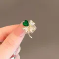 Elegant gold-tone four-leaf clover brooch featuring an emerald green heart crystal - Four-Leaf Clover (135#)