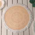 Macro view of Bohemian round woven placemat with white mandala pattern and fringe - Pattern 11