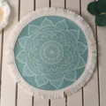 Detail view of teal bohemian round placemat with white mandala print and fringe trim - Pattern 12