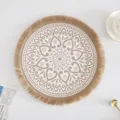 Detail view of a Nordic round jute placemat with bohemian mandala pattern and fringe edges - Tassel Style 5 / 38 cm