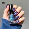 Macro detail of shimmering purple-blue cat-eye nail polish on elegant long nails. - Dopamine Cat Eye Nail Polish 01