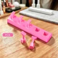 Close-up of dopamine pink heart-shaped nail art practice stand with five detachable holders. - Non-Magnetic Heart Nail Stand / Pink