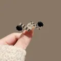 Elegant high-end vintage brooch featuring black and clear square crystals in gold - Black White Grid