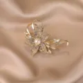 Close-up detail shot highlighting the sparkling crystal rhinestones and central pearl. - 558#