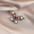 Detailed view of an elegant butterfly brooch with pink and green rhinestones and pearls - Pink and Green Silver Base Butterfly Style (766#)