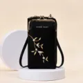Élégant sac de téléphone noir avec broderie florale et fermoir à baiser doré. - Noir