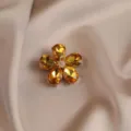 Exquisite vintage crystal flower brooch detail view, premium amber petals with pearl center. - Yellow