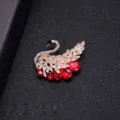Elegant gold-toned swan brooch with brilliant red teardrop crystals - Noble Swan Style
