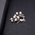 Elegant rose gold reindeer brooch adorned with white pearls and sparkling rhinestones - Reindeer Style