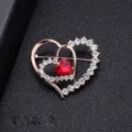 Elegant double heart shaped brooch featuring a central red crystal and rhinestones - Heart to Heart Style