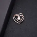 Elegant rose gold heart brooch featuring a center pearl and sparkling rhinestone accents - Heart Pearl Style