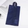Detailed view of the dark blue travel shoe bag with vertical zipper and durable handle. - Navy Blue