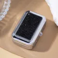 Detailed view of a silver chrome cigarette case with black rhinestone embellishment. - Black