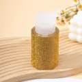 Detail view of a luxury 200ml refillable press bottle fully encrusted with yellow rhinestones - 200ml / Yellow