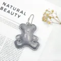 Detailed view of silver glittery leather bear keychain with metallic ball chain - Silver