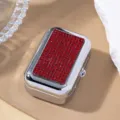 Detailed view of a portable silver metal cigarette case with vibrant red rhinestone inlay - Red