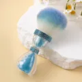 Detailed view of the blue rhinestone accents and gradient bristles on the makeup brush. - Hourglass Style / Lake Blue