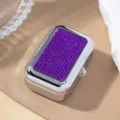 Detail shot of elegant purple rhinestone pattern on silver metal pill storage box - Purple