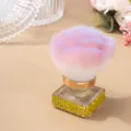 Detailed view of fluffy pink nail dust brush featuring a sparkling gold rhinestone square base - Yellow