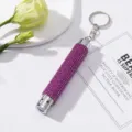 Detailed view of purple rhinestone LED flashlight keychain on elegant white background - Without Battery / Rose Red