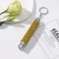 Close-up of yellow rhinestone-encrusted mini LED flashlight keychain on white card - Without Battery / Yellow