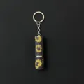 Macro detail of sparkly yellow and black rhinestone perfume atomizer keychain. - Sunflower