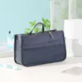 Dark blue multi-functional storage bag with double zippers, mesh pockets and handles. - Navy Blue
