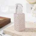 Nahaufnahme einer 5-ml-Lippenglossflasche, dekoriert mit Perlen und Strasssteinen. - Weiße Künstliche Perle und AB Strass
