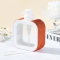 Detail view of a square refillable pump bottle decorated with orange rhinestones. - 300ml / Orange Red
