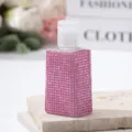Close-up detail of a pink rhinestone-encrusted travel spray bottle for perfume - 30ml / Pink