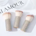Detailed view of three soft-bristle mushroom makeup brushes with rhinestone handles. - Three-Piece Set / AB White