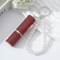 Detail of red rhinestone 5ml perfume atomizer with elegant white pearl wristlet strap - Red