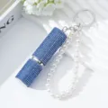Elegant detail of blue rhinestone 5ml perfume atomizer keychain with a white pearl strap - Blue