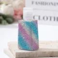 Detail view of a luxury rhinestone-covered empty perfume spray bottle on a stone platform - 30ml / Colorful Purple