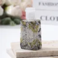 Detailed macro view of luxury rhinestone covered perfume spray bottle on stone - 30ml / Gold Silver Black Patchwork