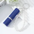 Detailed view of 5ml blue rhinestone perfume atomizer keychain with elegant pearl strap - Sapphire Blue