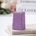 Macro view of a luxury travel perfume spray bottle covered in sparkly purple rhinestones - 30ml / Purple