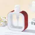 Close-up of white square dispenser bottle featuring elegant red rhinestone side panels - 300ml / Red