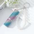 Detailed close-up of 5ml portable perfume atomizer with gradient rhinestones and pearl strap - Pink White and Blue Gradient