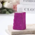 Detailed view of luxury purple rhinestone encrusted refillable travel spray bottle - 30ml / Rose Red
