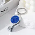 Detail of nail clipper bottle opener keychain with blue rhinestones - Sapphire Blue