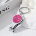 Close-up of pink rhinestone 2-in-1 nail clipper and bottle opener keychain tool - Rose Red