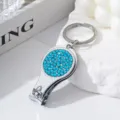Close-up detail of the sparkling blue rhinestones on the multipurpose nail clipper tool - Lake Blue