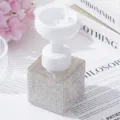 Close-up of luxury rhinestone foaming soap dispenser with flower-shaped pump head - AB White