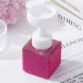 Close-up of pink rhinestone soap dispenser with elegant white flower foam pump - Rose Red