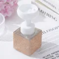 Detail of luxurious rhinestone foaming bottle with white flower pump dispenser head - Champagne Gold