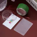Close-up of green rhinestone nail stamper with translucent floral pattern plate - Green