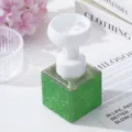 Close-up of green rhinestone soap dispenser with flower-shaped foam pump head - Green