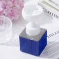 Macro view of blue rhinestone foam dispenser bottle with flower-shaped pump head - Sapphire Blue
